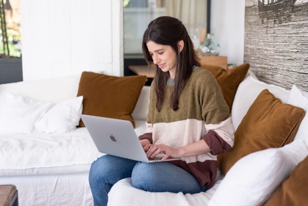 Mai with her laptop working from home